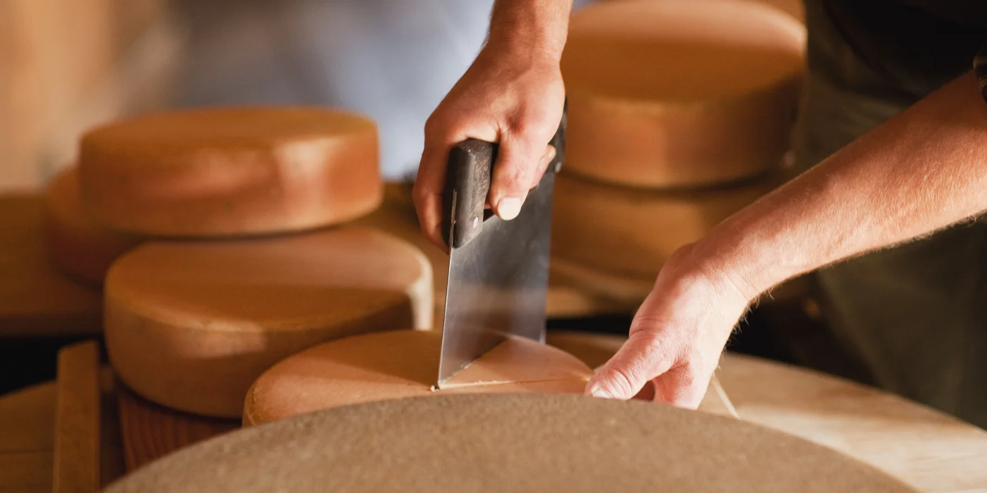Cut a slice from the cheese wheel